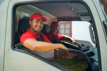Transport worker moving to new house sitting in cargo truck and smiling ready in service.