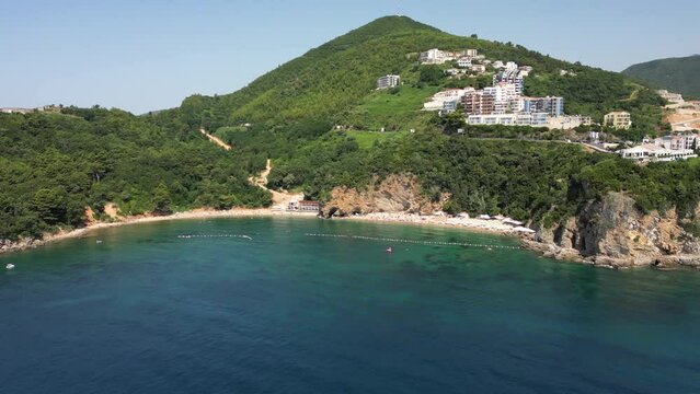 Beautiful top view of Mogren beach, clear sea and bathing people. Budva. Montenegro. Aerial view.