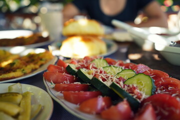 Close up of an albanian breakfast with fresh vegetables served at lake prespa, Albania.