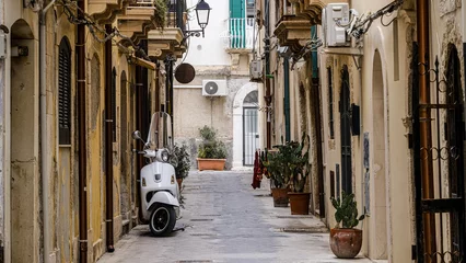 Foto op Aluminium scooter standing at the empty street of old italian town © nehuen