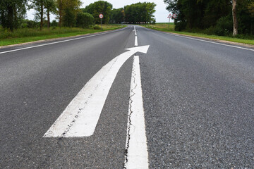 Asphalt road with markings and ending with a broken line