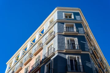 Gordijnen Luxury old residential buildings in Serrano Street in Salamanca neighborhood in central Madrid. Low angle view against sky © jjfarq