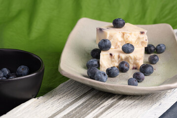 Blueberry cheddar cheese and fresh blueberries snack on serving tray. 
