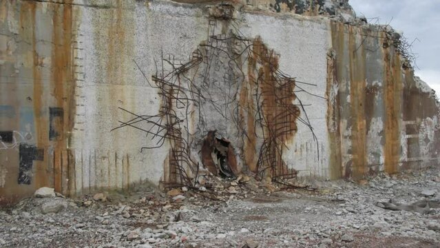 Abandoned old russian soviet style gas chemical processing factory plant ruins basement concrete core with orange dyed fragments and stones

