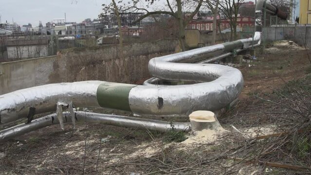 District heating pipeline in the park, construction, cut tree