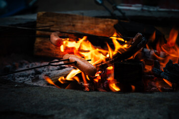 Hotdog roasting over a camp fire