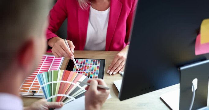 People in the office choose a sample from a color palette, a close-up. Designer studio, color combination