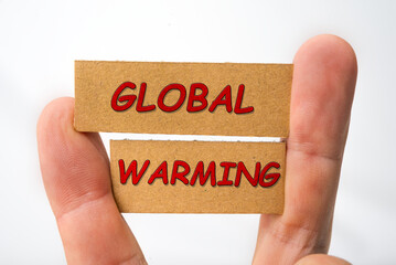 Global warming sign on a cardboard on a white