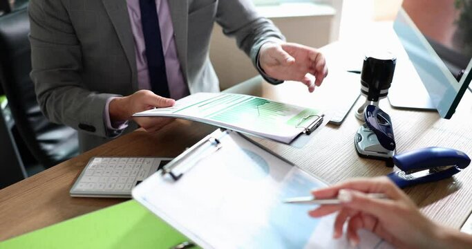 People in the office watch reports, close-up, slowmotion. Concept business activity, financial reliability