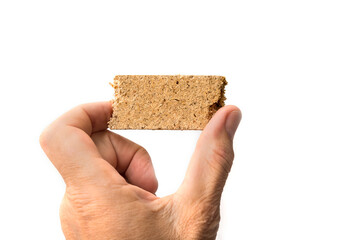 Piece of Plain Particle Board between fingers