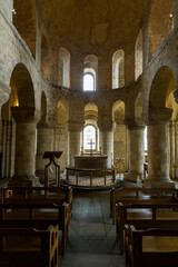 The interior of an old church with columns, windows and a pulpit in Europe