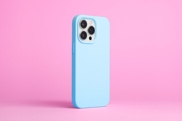 iPhone 15 Pro in blue case back side view isolated on pink background, phone case mock up