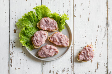 Toasts with tarama or taramasalata canape on the white wooden table