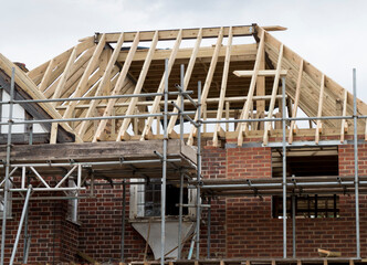Europe, UK, England, Surrey, scaffolding on house roof renovation