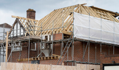 Fototapeta Europe, UK, England, Surrey, scaffolding on house roof renovation obraz