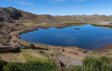 Fototapeta na wymiar Small lake in the remote Bolivian Andes between Torotoro and Oruro - Traveling and exploring wild places in South America
