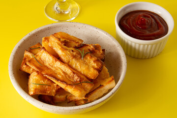 Top view Delicious Fried Cassava in Handcrafted White Ceramic Bowl on Yellow Studio Background