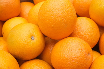 background of juicy oranges freshly picked from the tree , sweet citrus fruit