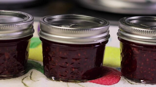 Raspberry jam in canning jars pan
