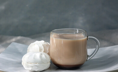 Cup of coffee with milk on tray, on light blue background, close-up. Space for copy. Space for text. Concept of new day, romance, freshness.