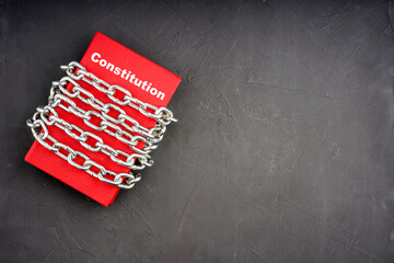 the inscription on the red book is the constitution, the book is chained
