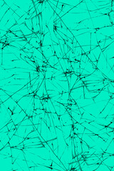 Abstract lines of cracks on the glass on a turquoise background.