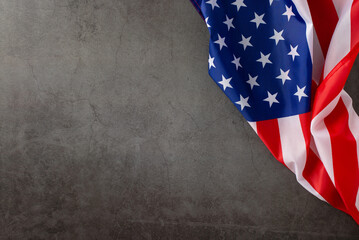 Public holiday tribute: Engage your audience with this top-down snapshot, highlighting American flag on grunge textured grey concrete background. Ample space for adverts or text during the celebration