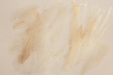 Beige, gold, ink and watercolor smoke flow stain blot on wet paper grain texture background.