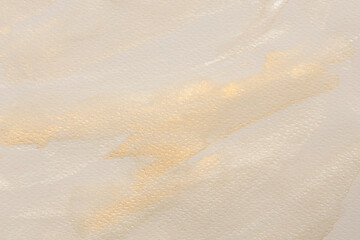 Beige, gold, ink and watercolor smoke flow stain blot on wet paper grain texture background.