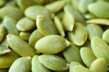 Green peeled pumpkin seeds texture close up