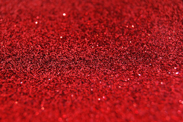 Red de focused sparkle glitter background close up
