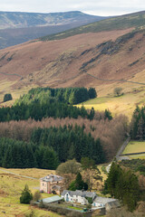 Idyllic vertical view, County Wicklow, Ireland. Mountains, close to Guinness lake and tourists walking paths. Typical Irish cottage.and farm