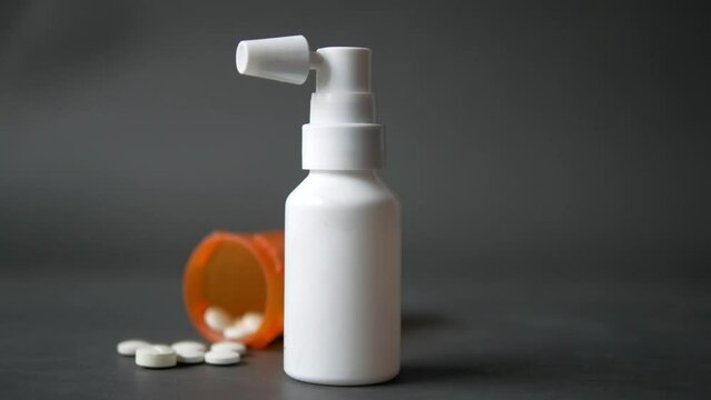 ear drop and medical pills on black background 