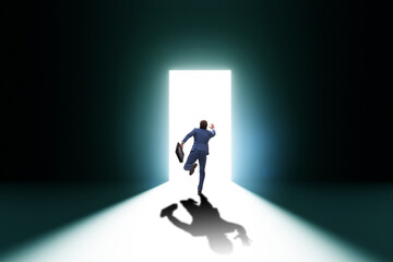 Businessman entering backlit door in escape concept