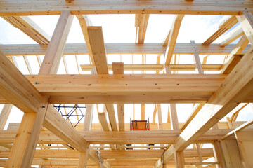 Obraz premium Frame of wooden house. Construction of building from boards. Frame of unfinished cottage. Building house from lumber. Unfinished frame house. Real estate construction. Lumber sale concept