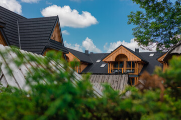 Detail of Typical houses or villas in Zakopane, a known polish summer and winter retreat place. Main road and wooden houses next to it, fancy and beautiful.