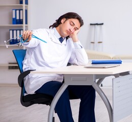 Young doctor being tired after night shift