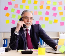 Aged man employee in conflicting priorities concept