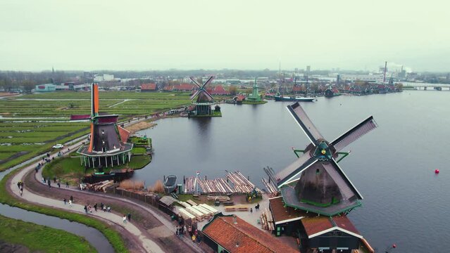 Drone view over Zaanse Schans windmills museum near the canal, Netherlands. High quality 4k footage
