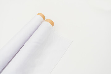 A minimalistic backdrop provides a serene and stylish context for the mockup of the white fabric roll image