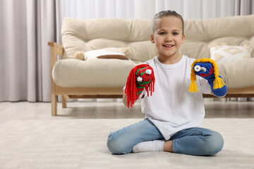 Happy daughter with funny sock puppets playing at home, space for text