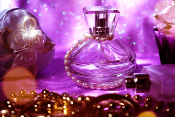 Obraz na płótnie Canvas Women's luxury accessories, golden necklace, perfume. Dressing table with fashion details close up, lavender coloring and soft blurred sunlight flares. Retro, grace and elegance. Vanity table