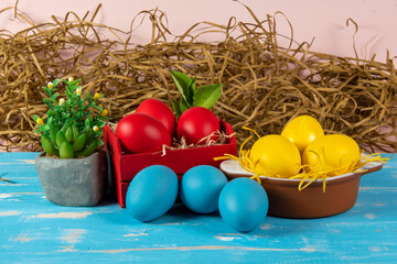 eggs in wooden box with hay on rustic background or surface, easter or holiday concept