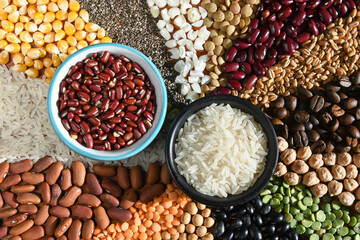Bowl with raw white rices and beans on various seeds grain