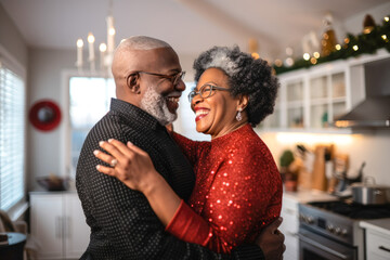 Authentic moment of an African American retired couple sharing a dance in the kitchen, an...