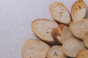Delicious croutons. Pieces of roasted white bread. Sliced bread on a table, top view.