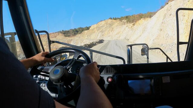 Pov of driving a loaded truck is riding along the copper mine deposit