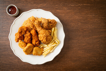 fried chicken with french fries and nuggets on plate