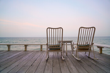 Fototapeta na wymiar empty chair on balcony with sea background