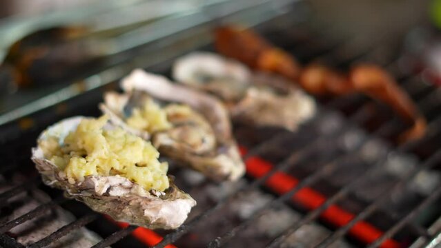 Cheese is applied to seafood oyster in row
